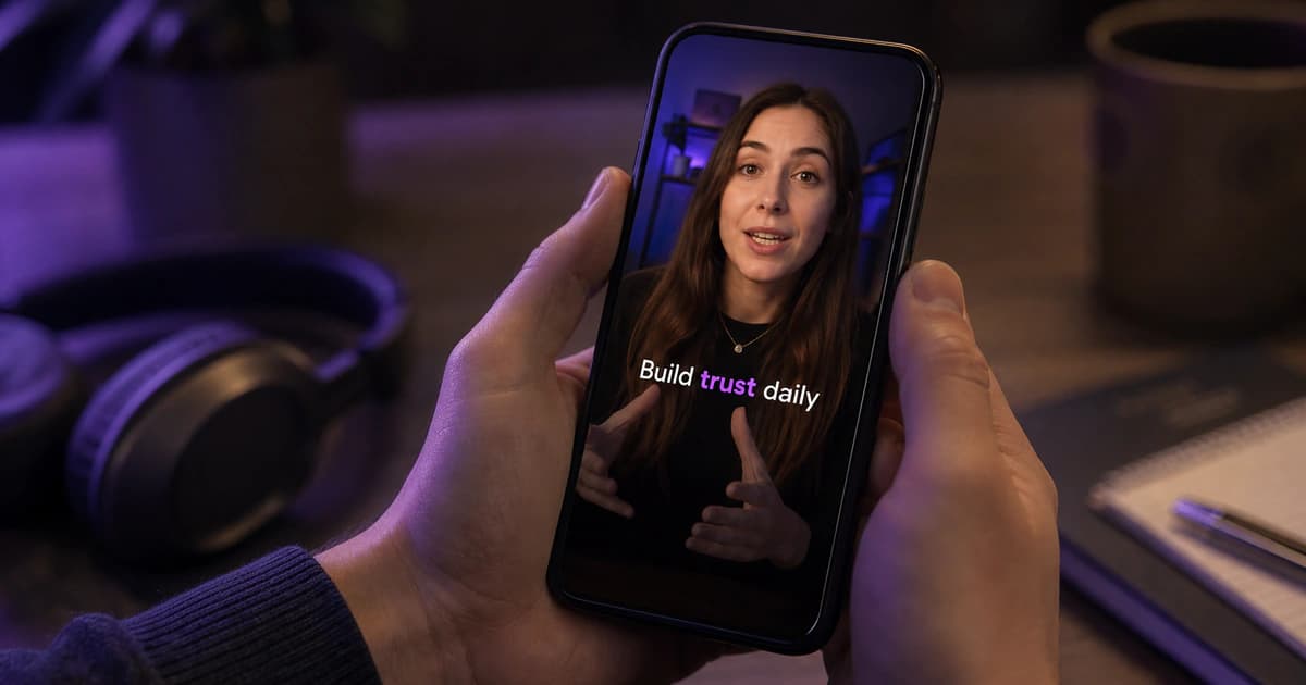 Phone playing a vertical creator video with one caption word highlighted